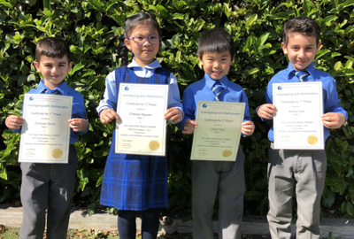 Our Lady of the Rosary Catholic Primary School Fairfield Year 1 maths competition winners hold up their certificates